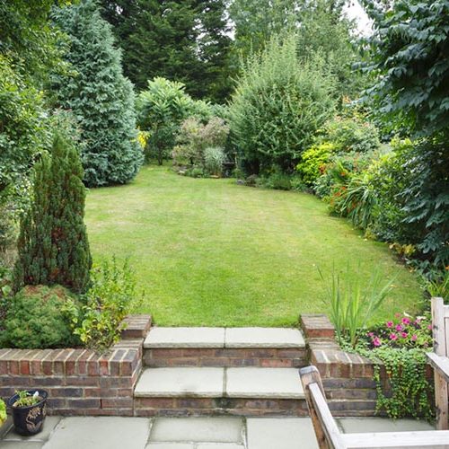 Patio garden area leading out into the grass